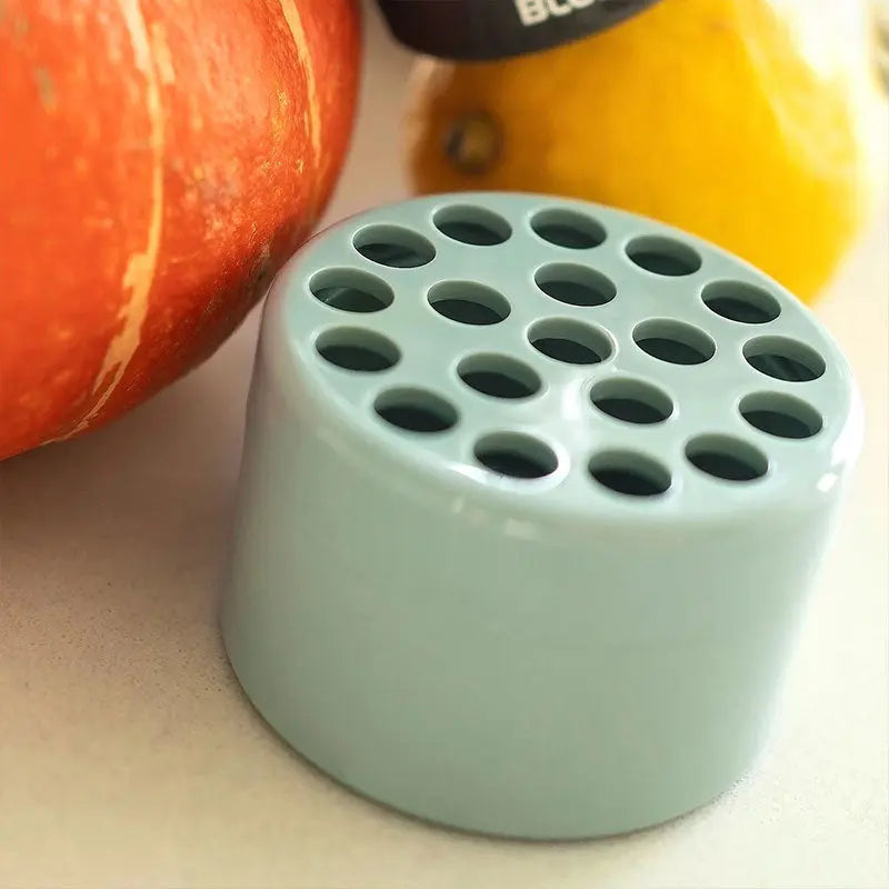 Green ceramic Blumenhalter für Vasen Stielraster with perforated holes beside pumpkin