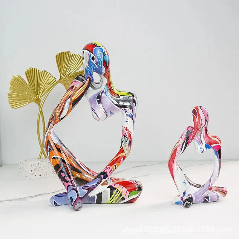 Two colorful Abstrakte Denker Skulptur pieces with vibrant graffiti-style patterns