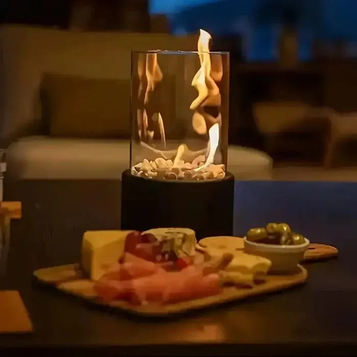 Tragbare Tischfeuer-Laterne beside cheese platter on wooden board