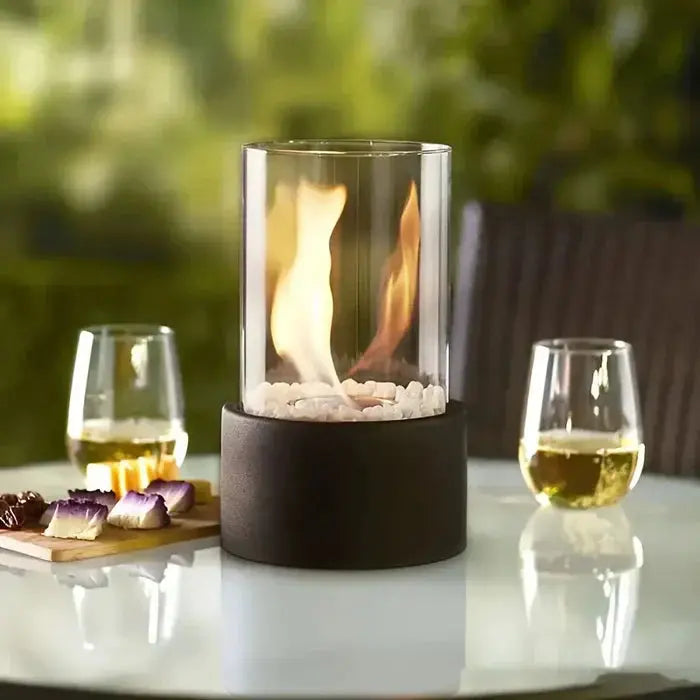 Tischfeuer-Laterne with wine glasses and snacks on white table