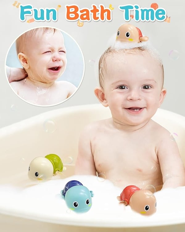 Happy toddler playing with Aufzieh-Schwimmschildkröten Badespielzeug set during fun bath time